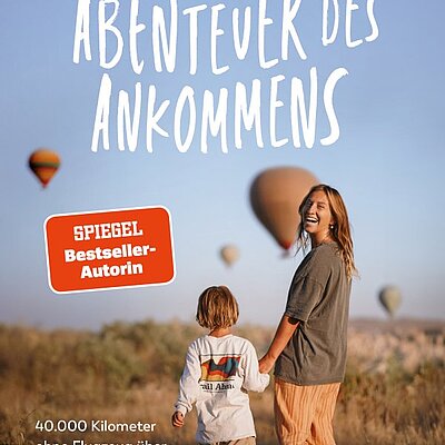 Frau und Kind vor aufsteigenden Heißluftballons